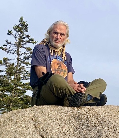 Dr. Watson sitting on a rock on the Maine coast